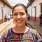Smiling woman in traditional embroidered dress during a retreat day in Colombia